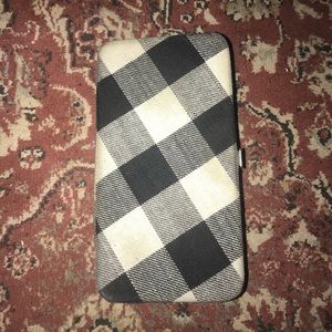 black, white, and grey woman’s clutch wallet